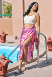 Turn heads in this floral pink sarong wrap skirt and off-white crop top – the perfect beach vacation outfit for curvy women. Explore resort chic attire, ideal for poolside lounging or beach club outings. Sizes S–7XL available at NovelaFashion.