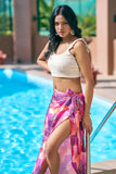 Turn heads in this floral pink sarong wrap skirt and off-white crop top – the perfect beach vacation outfit for curvy women. Explore resort chic attire, ideal for poolside lounging or beach club outings. Sizes S–7XL available at NovelaFashion.